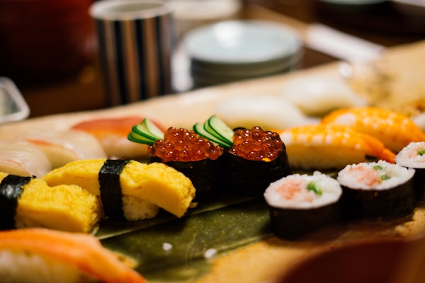 A selection of sushi served on a dark plate